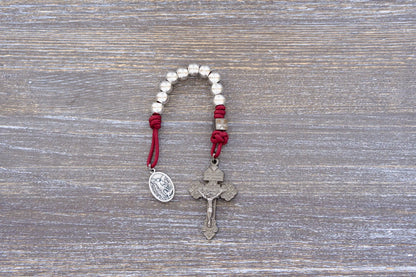 Premium metal pocket paracord rosary with gunmetal pardon crucifix, available in navy, maroon, or iron gray.