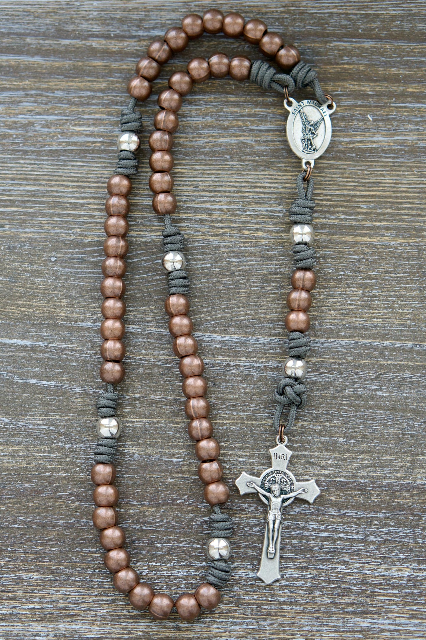 St. Michael's Sword - Premium Metal Paracord Rosary with grey paracord, silver Our Father and copper Hail Mary beads, silver St. Michael centerpiece and St. Benedict crucifix.