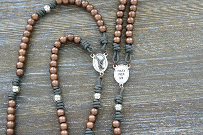 Premium Metal Paracord Rosary featuring rugged paracord, alloy metal Hail Mary beads in copper, silver Our Father beads, silver St. Michael centerpiece devotional medal, and a 2" St. Benedict crucifix.