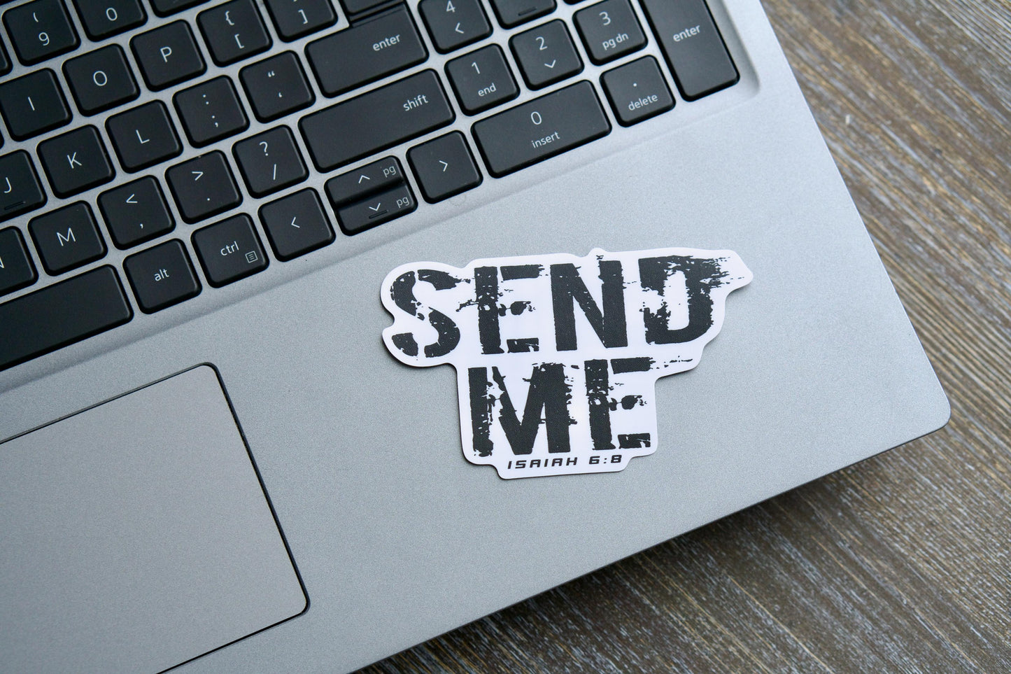 Bold white vinyl sticker featuring the iconic text 'Send Me' from Isaiah 6:8, measuring 3.75" x 2.34". Semi-glossy finish with matte lamination for durability and UV resistance. Ideal for laptops, water bottles, and more, conveying a powerful call to action for traditional Catholic discipleship.