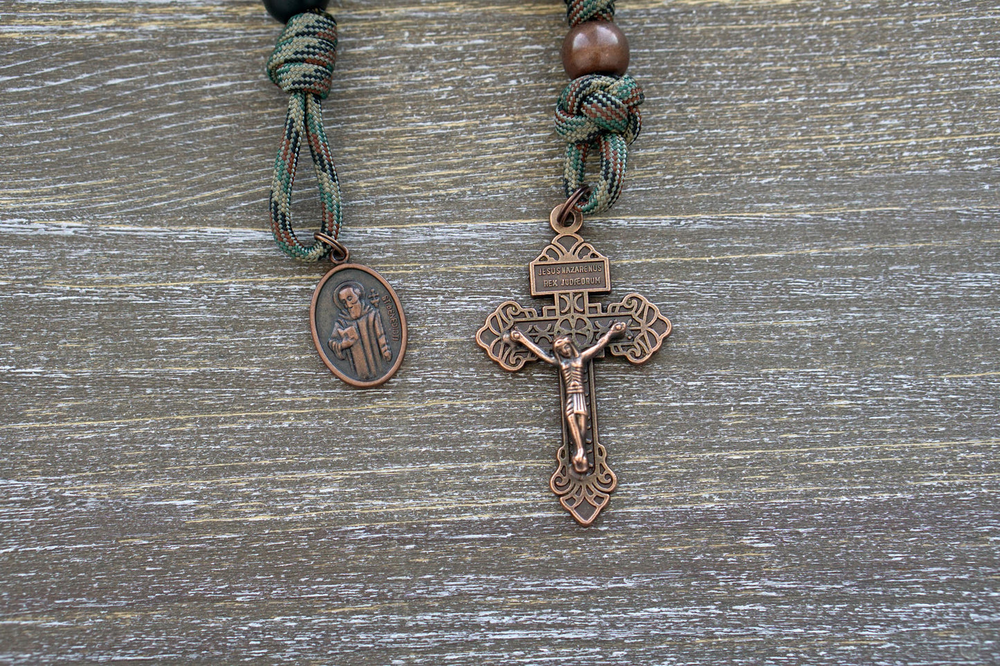 "The Serpent Slayer" Pocket Paracord Rosary - A powerful, matte black and antique copper rosary with a pardon crucifix and St. Benedict medal, designed for devout Catholics to combat evil in their lives.