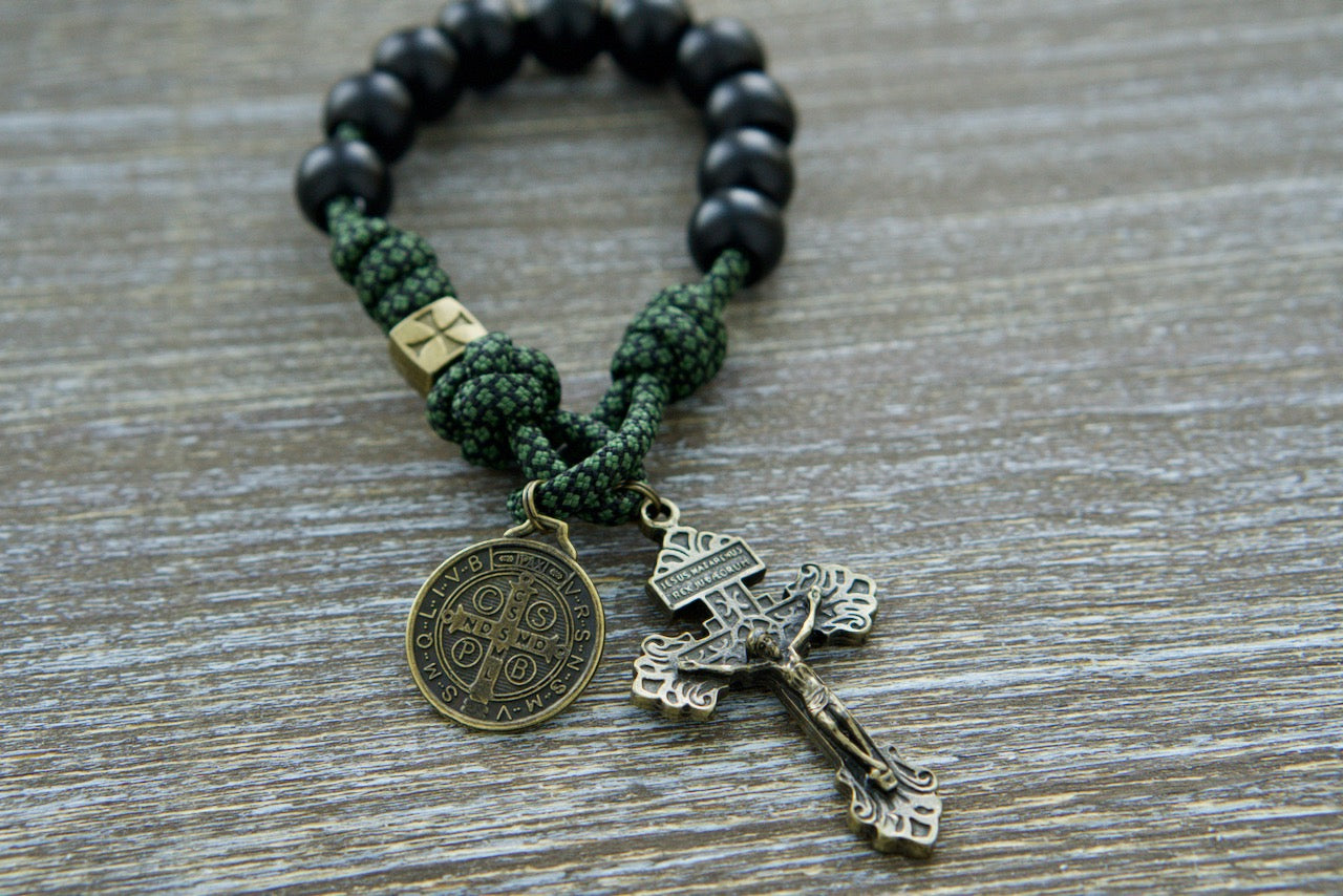 Shield of Faith - Green, Black and Olive - 1 Decade Paracord Rosary: Durable green camo paracord rosary with black Hail Mary beads, bronze Crusader cross Our Father beads, a bronze 2" Pardon Crucifix, and St. Benedict medal for spiritual protection on your faith journey.