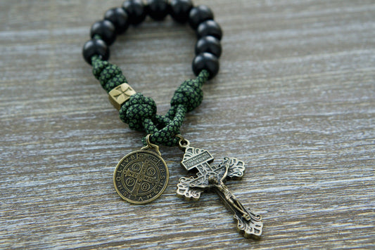 Shield of Faith paracord rosary in green camo with bronze accents, matte black beads, and St. Benedict medal.