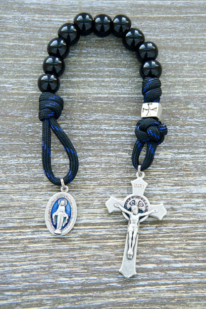 Embark on a solemn journey of devotion with our 'Solemn Crusader' Blue Black and Silver 1 Decade Paracord Rosary. Experience unwavering faith as you hold this durable, premium rosary crafted for those seeking strength in their Catholic journey. 