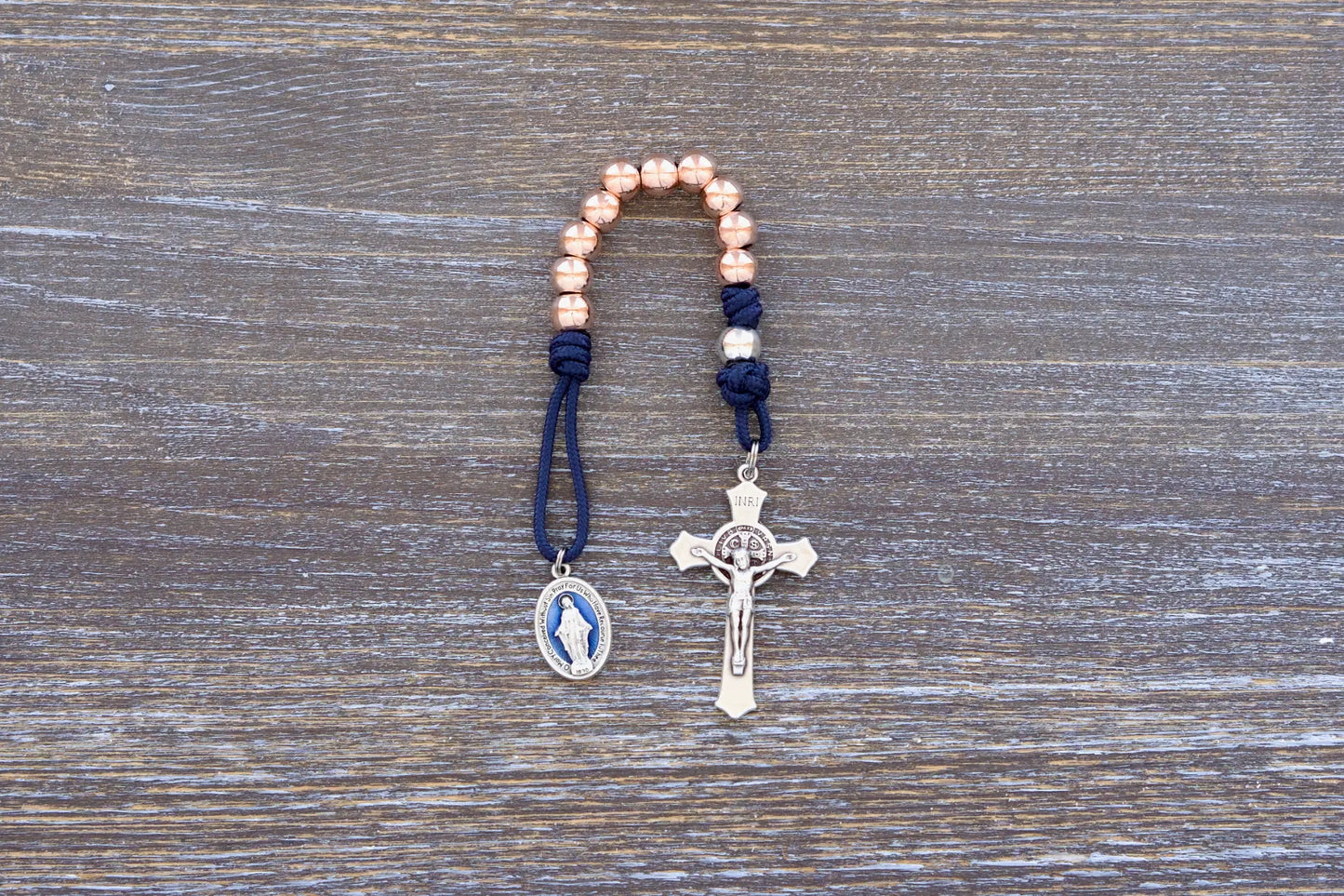 Splendor of the Stars paracord rosary with rose gold beads, crucifix, and blue enamel miraculous medal.