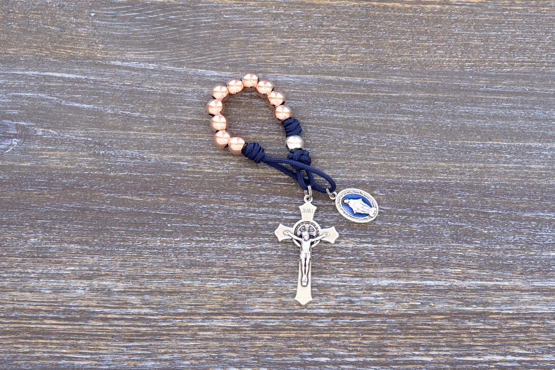 Splendor of the Stars paracord rosary with rose gold metal beads, crucifix, and blue enamel miraculous medal