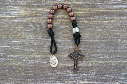 St. Anthony Heretic Hammer Pocket Paracord Rosary - Handmade Catholic accessory featuring black paracord, copper and pearl beads, St. Anthony medal, and Pardon Crucifix; durable for daily devotions and available in full size or single decade.