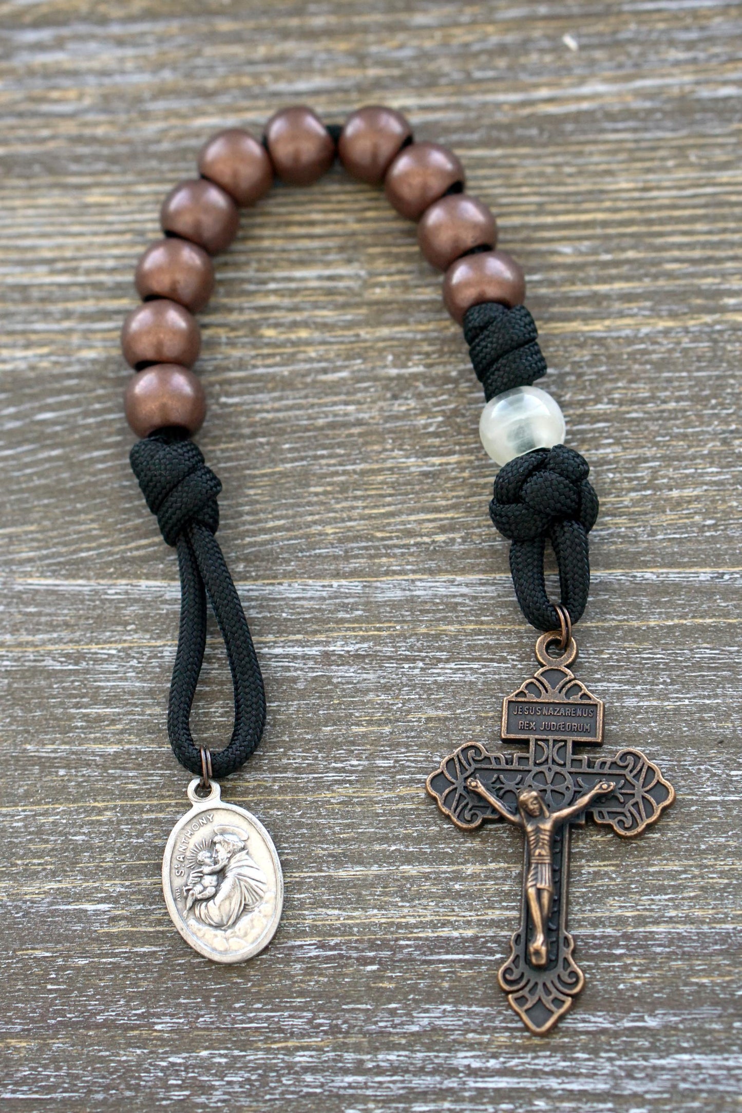 St. Anthony Heretic Hammer Pocket Paracord Rosary - Durable black paracord rosary with copper and pearl beads, St. Anthony devotional medal, and pardon crucifix.