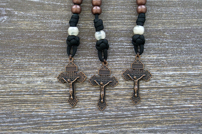 The Heretic Hammer - St. Anthony Pocket Paracord Rosary in black rope with copper and pearl beads, featuring a St. Anthony devotional medal and a 2-inch Pardon Crucifix for daily devotions and spiritual protection.