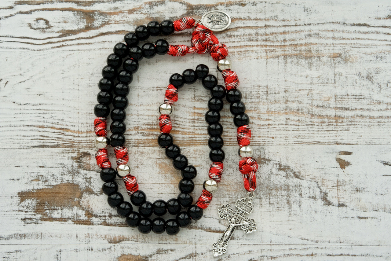 Unleash the power of St. Florian's Strength with our 5 Decade Paracord Rosary designed for Firefighters, EMS professionals, and first responders! This unbreakable paracord rosary is a premium Catholic gift for those who face life's toughest battles every day. Featuring durable black beads, a silver Pardon Crucifix, and Saint Florian Medal.