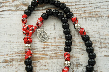 Stand strong in faith with St. Florian's Strength - 5 Decade Paracord Rosary designed for firefighters, EMS professionals, and first responders. Durable, unbreakable paracord rosary featuring premium quality black beads, a silver Our Father bead, and a Pardon Crucifix with St. Florian Medal.