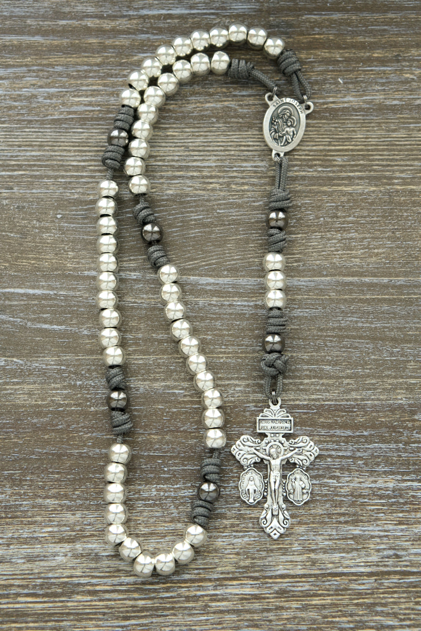 Unbreakable paracord rosary, St. Joseph protection, premium Catholic gift for daily prayers, unwavering strength and devotion, durable and resilient grey paracord, all-silver alloy Hail Mary beads, gunmetal Our Father beads, silver 2" Pardon Crucifix, St. Joseph centerpiece, traditional Catholic rosary accessory