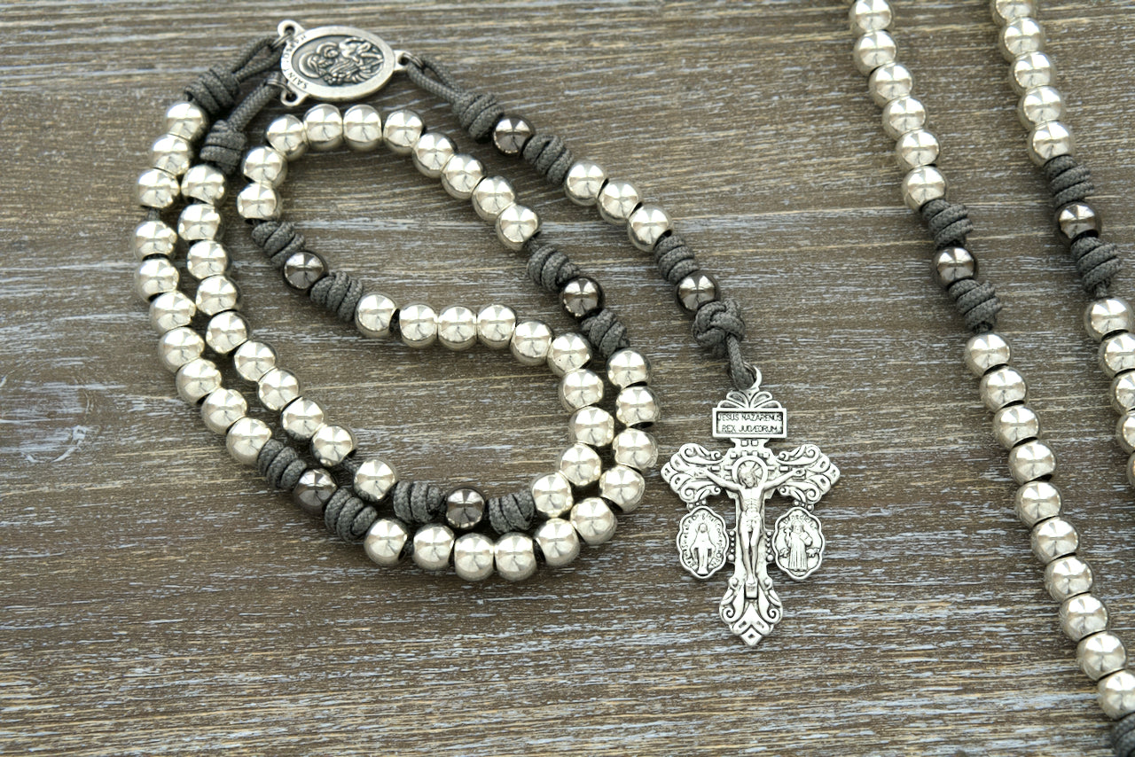 Unbreakable paracord rosary with silver alloy beads and St. Joseph centerpiece, perfect for devoted Catholics seeking a durable spiritual companion.