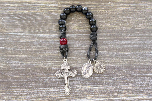 Black and white luster Hail Mary beads with red/maroon Our Father bead, St. Joseph and St. Benedict medals, Pardon Crucifix, and paracord 550 construction form a powerful, handmade rosary for spiritual protection against evil.