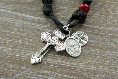 Unleash the power of protection with our new "Terror of Demons" 1 Decade Paracord Rosary, featuring striking black/white cats eye beads and a double devotional medal pairing of St. Joseph and St. Benedict.