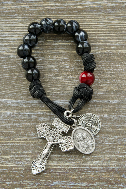 Embark on a spiritual journey with our durable and unbreakable "Terror of Demons" rosary, featuring a striking black/white cats eye Hail Mary beads and red/maroon Our Father bead.