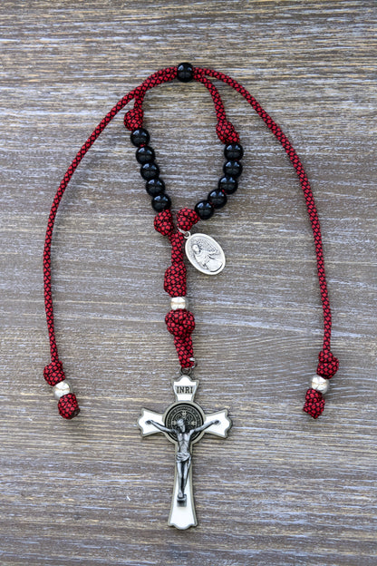 St. Maximilian Kolbe Rearview Mirror Rosary, compact red paracord rosary featuring a large white enamel crucifix and black beads for daily travel.