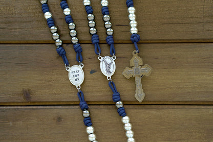 St. Michael Chaplet - Navy blue and gunmetal paracord chaplet featuring 10mm metal alloy beads, a silver St. Michael medal centerpiece, and a Pardon crucifix.