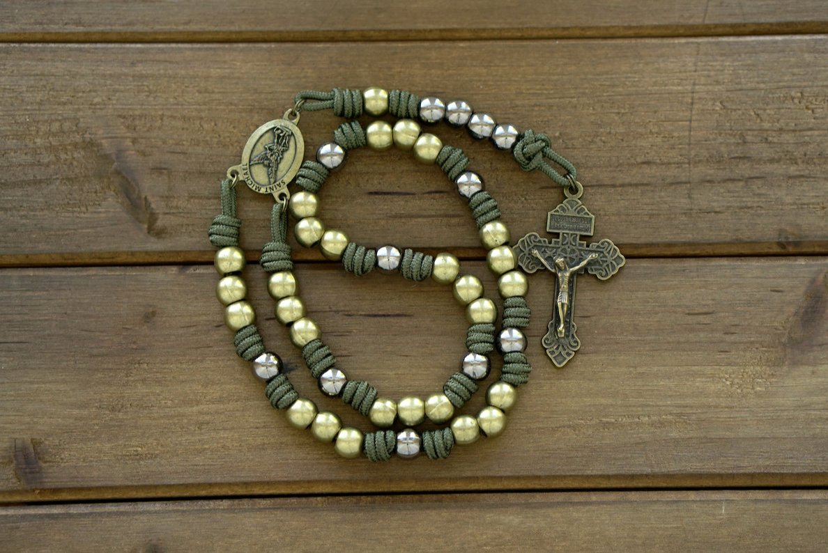 St. Michael Chaplet - Olive and Gunmetal: A handmade paracord chaplet featuring Army Green cord, olive Pardon Crucifix and Hail Mary beads, gunmetal Our Father beads, and an olive St. Michael centerpiece. Durable and reverent.