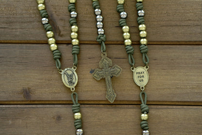 St. Michael Chaplet - Olive and Gunmetal: A handcrafted paracord chaplet featuring an olive Pardon crucifix, olive Hail Mary beads, gunmetal Our Father beads, and a striking olive St. Michael centerpiece.