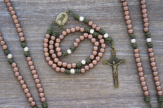 St. Michael's Shield Premium Metal Paracord Rosary:  A handcrafted rosary featuring green paracord interwoven with copper Hail Mary beads and silver Our Father beads, accented by an olive St. Michael centerpiece medal and a 2.5" St. Benedict crucifix.