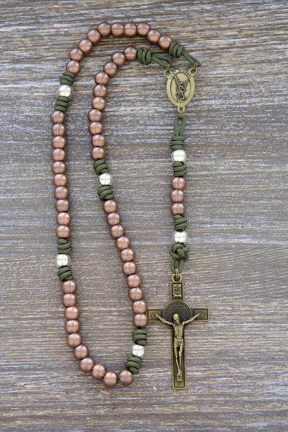 Premium metal and green paracord St. Michael's Shield Rosary featuring copper Hail Mary beads, silver Our Father beads, a radiant olive St. Michael centerpiece medal, and a 2.5 inch olive St. Benedict crucifix. Handcrafted with durable Paracord 275.