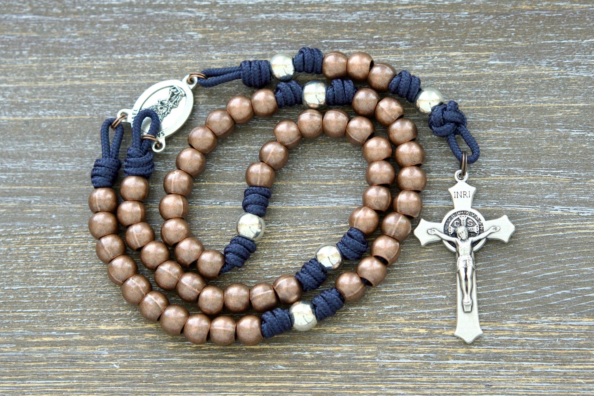 St. Michael's Sword Premium Metal Paracord Rosary: A handcrafted rosary featuring durable paracord in grey, black, green, or navy blue, with gleaming copper Hail Mary and silver Our Father beads.