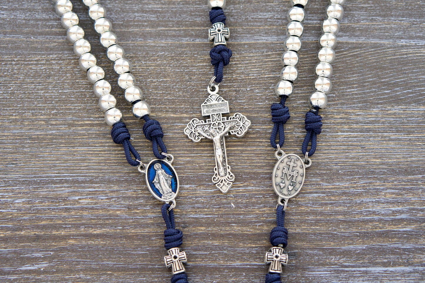 Premium Stella Maris Rosary - Handmade paracord rosary featuring navy blue cord, 10mm silver metal Hail Mary beads, a blue enamel Miraculous Medal centerpiece, and a silver Pardon Crucifix. Inspired by Our Lady, Star of the Sea.