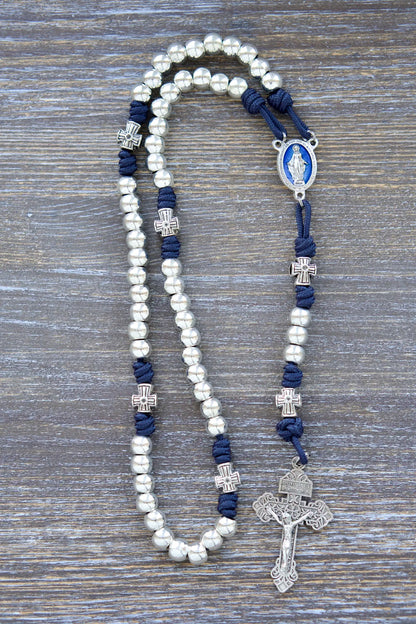 Stella Maris Rosary: Navy blue paracord with silver metal Hail Mary and cross-shaped Our Father beads, accented by a blue enamel Miraculous Medal and silver Pardon Crucifix.