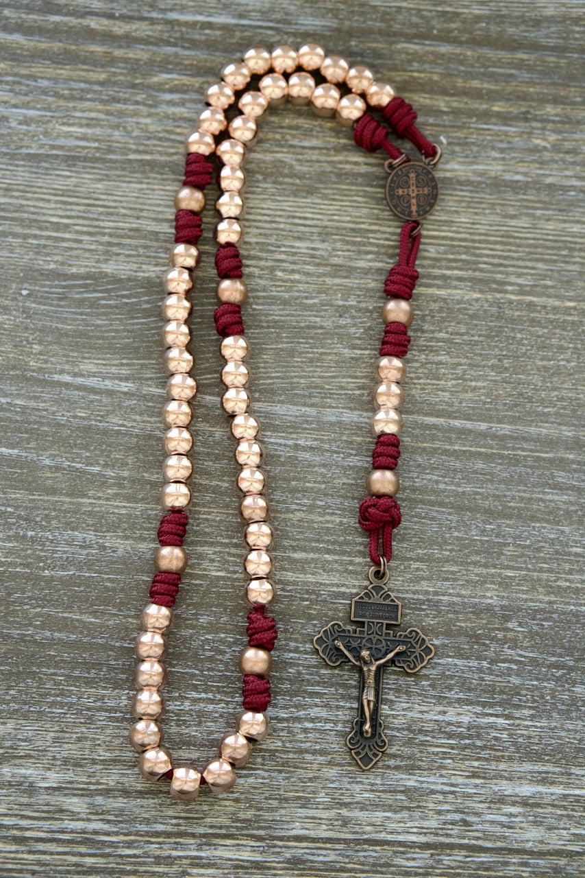 Premium Metal Maroon and Rose Gold Paracord Rosary with Antique Copper Beads, featuring a matching copper St. Benedict Centerpiece and 2-inch Copper Pardon Crucifix, perfect for daily devotion and spiritual protection. (Strength & Virtue)