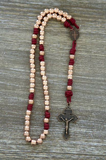 Premium Metal Maroon and Rose Gold Paracord Rosary with Antique Copper Beads, featuring a matching copper St. Benedict Centerpiece and 2-inch Copper Pardon Crucifix, perfect for daily devotion and spiritual protection. (Strength & Virtue)