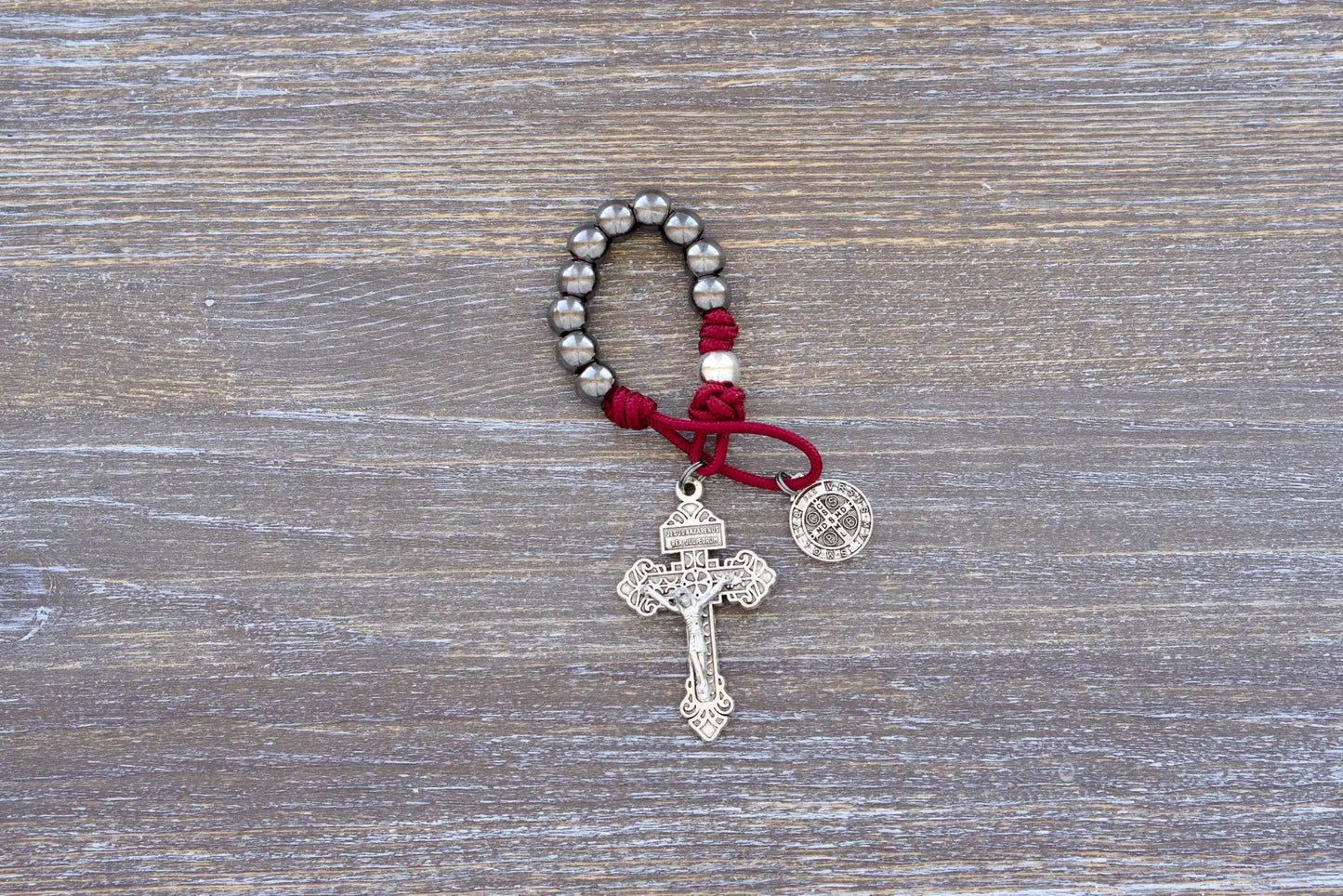 Sword of the Faithful pocket paracord rosary with gunmetal beads, St. Benedict medal, and 2-inch Pardon crucifix.