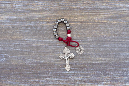 Sword of the Faithful pocket paracord rosary with gunmetal beads, St. Benedict medal, and 2-inch Pardon crucifix.