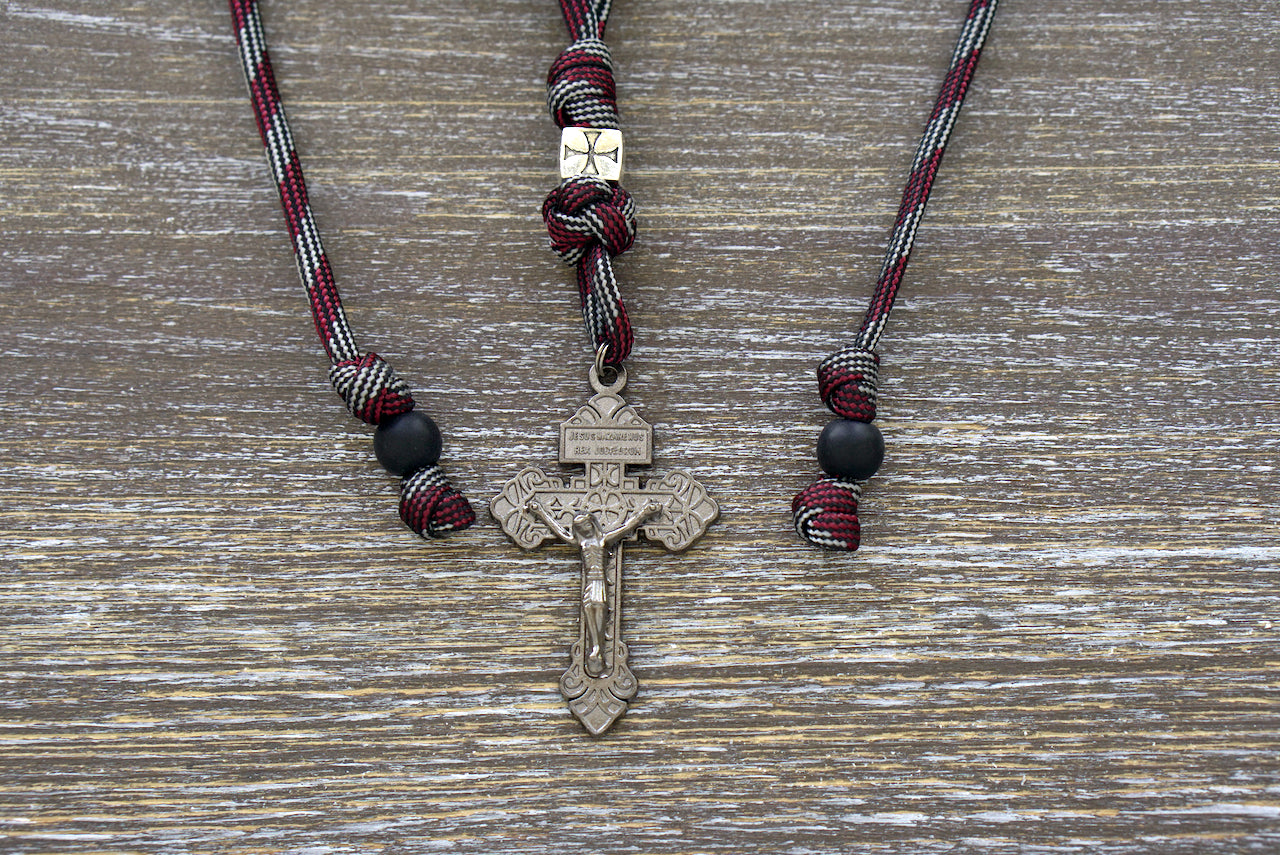 The Crusader Rearview Mirror Paracord Rosary, a handmade Catholic prayer accessory crafted with high-quality paracord and featuring a metal Crusader Our Father bead, 10mm acrylic beads, and a gunmetal Pardon Crucifix.