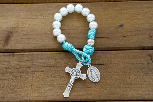 The Peaceful Waters - Teal Blue and White Pocket Paracord Rosary from Sanctus Servo, featuring durable paracord 550 rope, pearl Hail Mary beads, silver Our Father beads, a standard size 2" St. Benedict Crucifix, and a Miraculous Medal 