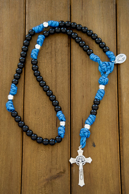 The Royal Warrior | Blue, Black & Silver | 5 Decade Paracord Rosary - Unbreakable, durable Catholic rosary designed for kids with royal blue paracord, black acrylic beads, silver Our Father beads and a St. Benedict Crucifix. Perfect spiritual companion for young Catholics.