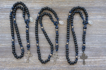 Thin Blue Line - 5 Decade Paracord Rosary: Camo paracord, matte black Hail Mary beads, gunmetal Our Father beads, and a devotional medal featuring St. Michael and a Guardian Angel. 