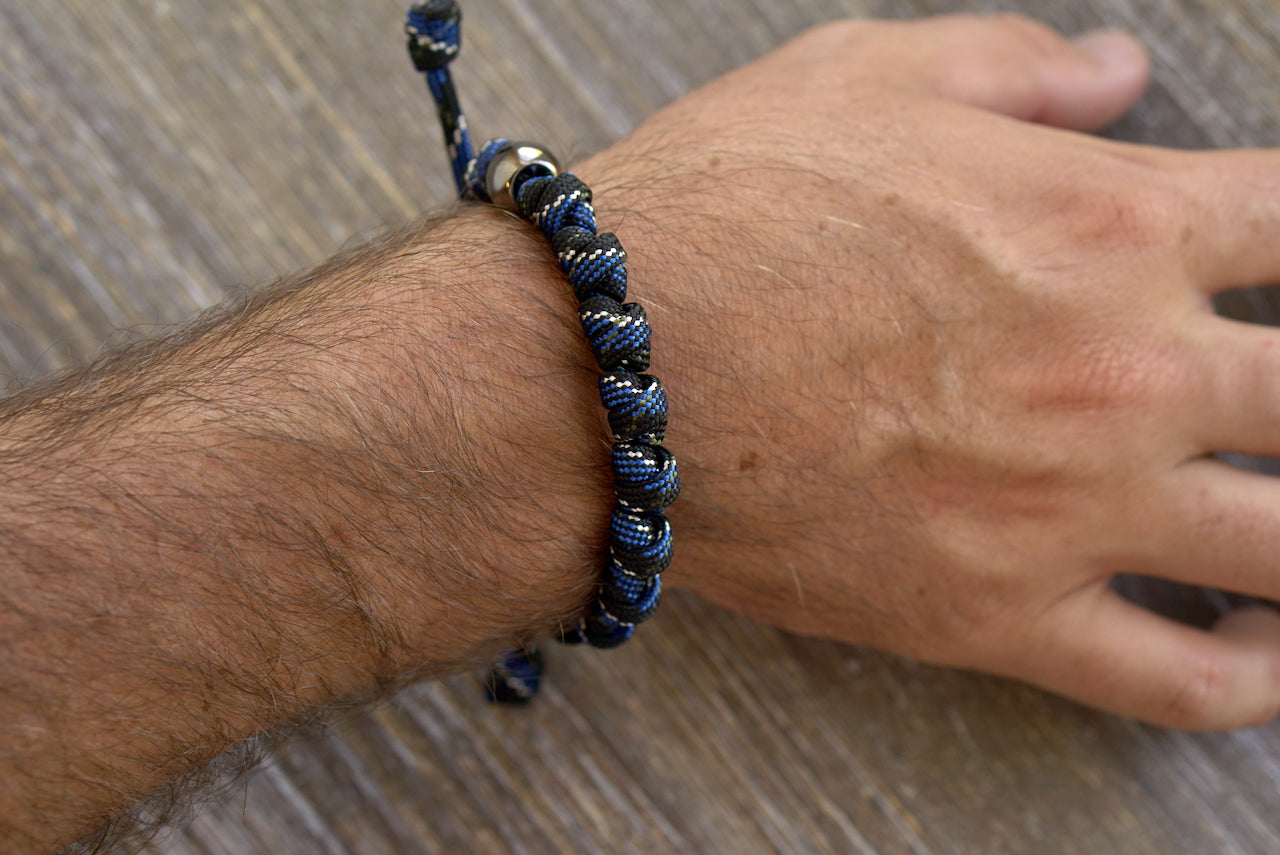 Thin Blue Line Rosary Bracelet - Modern, stylish, and spiritual paracord bracelet featuring blue, black, and silver colors.