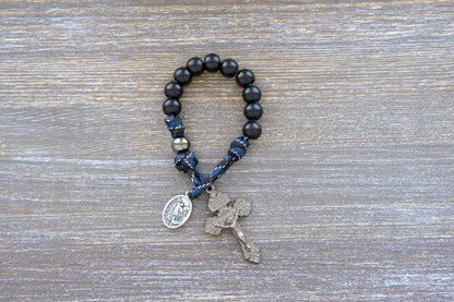 Thin Blue Line Pocket Rosary: Black and blue camo paracord with gunmetal & matte black acrylic beads, featuring a St. Michael medal and gunmetal crucifix.