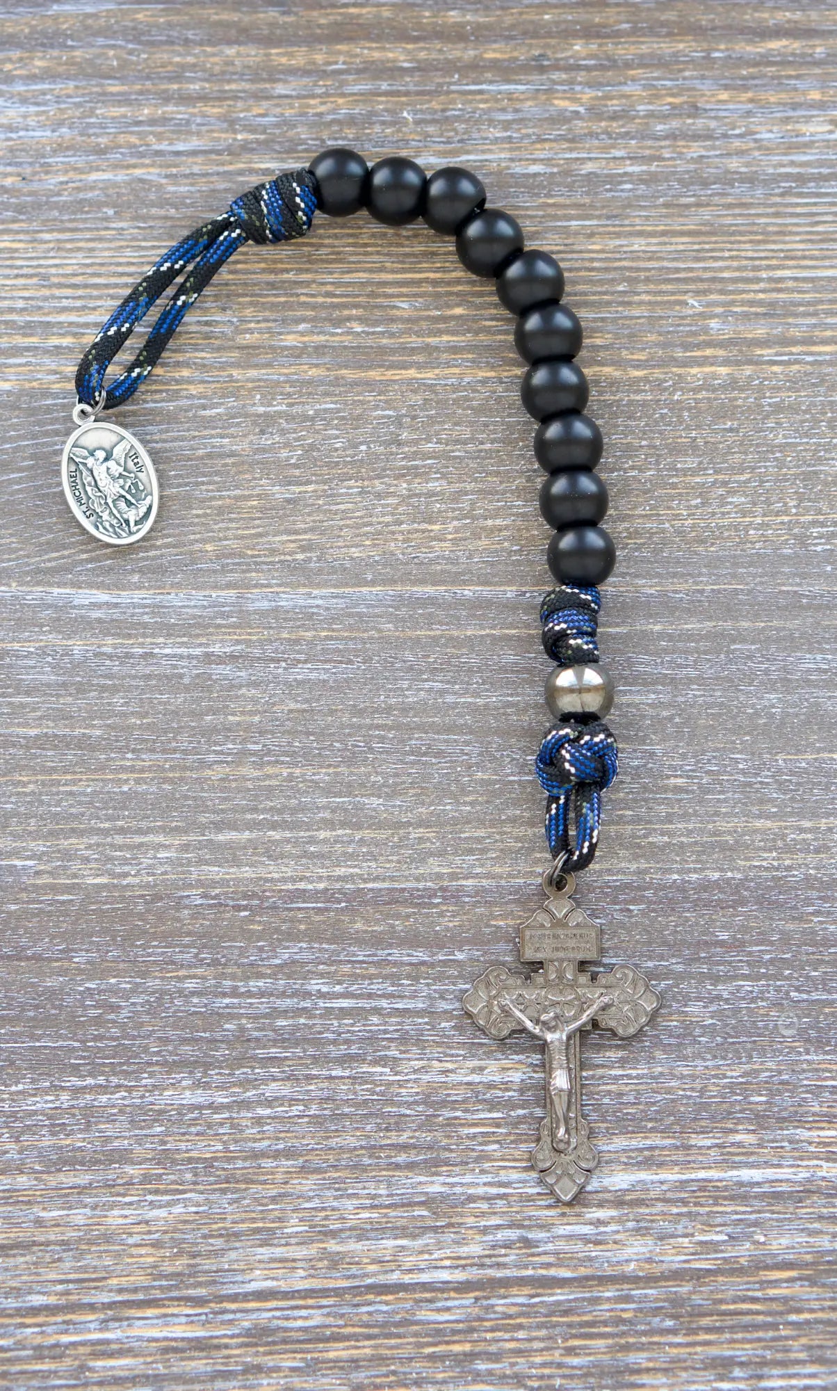 Thin Blue Line Pocket Paracord Rosary: gunmetal and matte black beads on camo paracord, with St. Michael medal and Pardon crucifix.