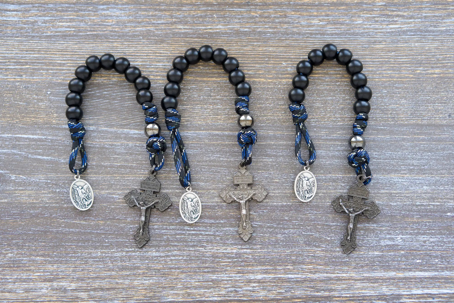 Thin Blue Line Pocket Paracord Rosary: gunmetal & matte black beads, camo paracord, St. Michael medal, and gunmetal crucifix.