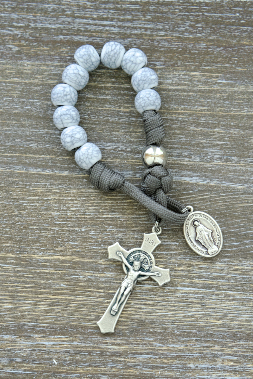 Tower of Ivory - Pocket Paracord Rosary: Exquisite and durable 1 decade rosary featuring cracked ivory-look Hail Mary beads, silver Our Father beads, dark grey paracord, St. Benedict crucifix, and Miraculous Medal for Catholic devotion.