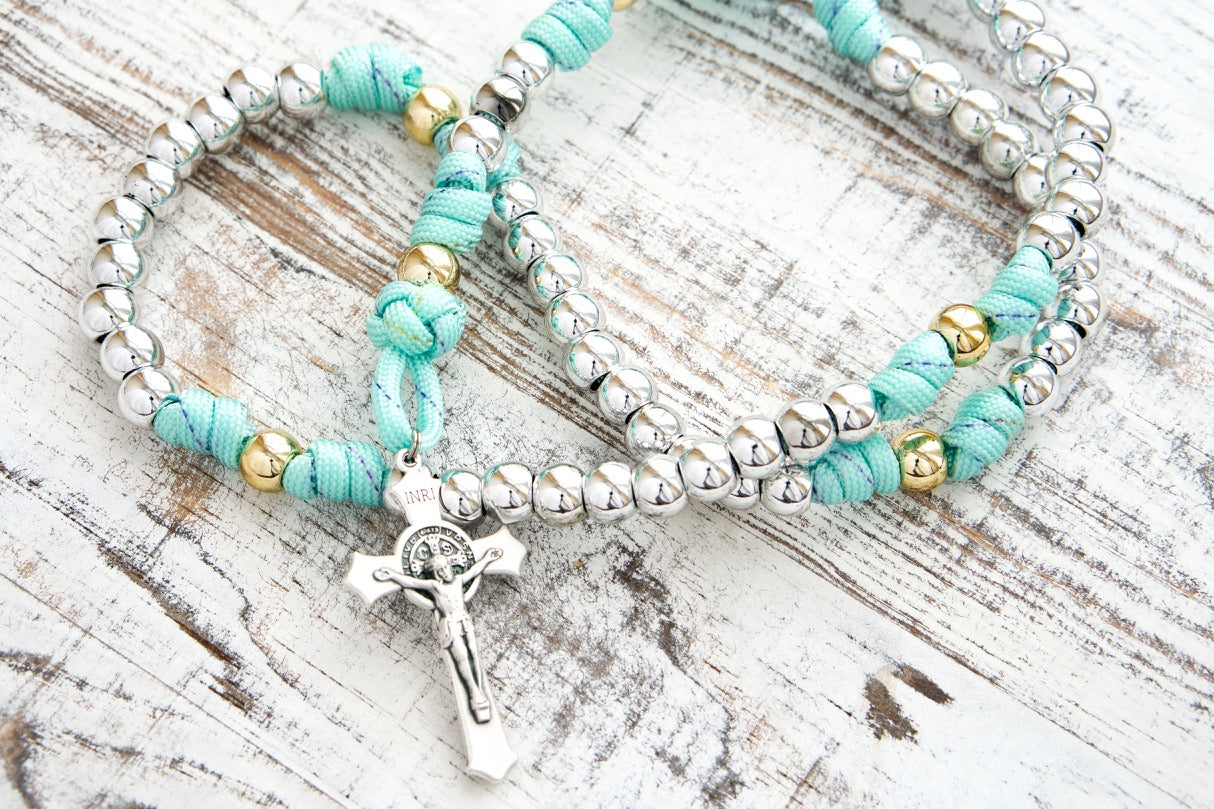 August Queen of the Heavens - Teal Blue, Gold, and Silver - 5 Decade Paracord Rosary: Beautiful, sturdy rosary with teal blue paracord, rainbow ribbon, royal silver and gold beads, St. Benedict Crucifix, and Miraculous Medal.