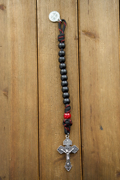 The Blood of Christ - 1 Decade Paracord Rosary, a powerful symbol of faith and devotion, honoring Jesus' sacrifice on the cross. This durable, premium paracord rosary features a silver pardon crucifix, St. Benedict medal, and stylish black & red rope with black & maroon/red beads, perfect for daily use or special occasions.