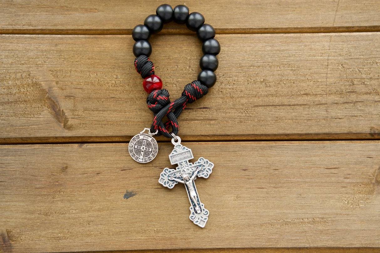 The Blood of Christ - 1 Decade Paracord Rosary: A powerful and durable Catholic gift that honors Jesus' sacrifice on the cross. Featuring a silver pardon crucifix, St. Benedict medal, and stylish black and red rope with black and maroon/red beads.