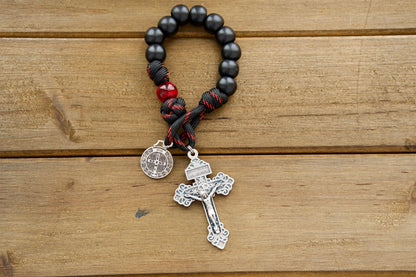 The Blood of Christ - 1 Decade Paracord Rosary: A powerful and durable Catholic gift that honors Jesus' sacrifice on the cross. Featuring a silver pardon crucifix, St. Benedict medal, and stylish black and red rope with black and maroon/red beads.