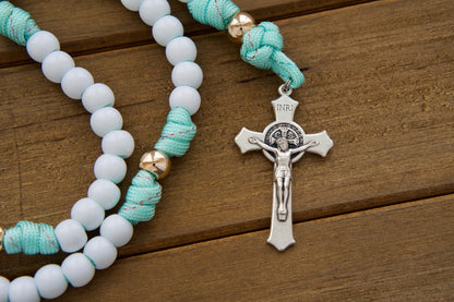 Kid's mint green paracord rosary with white Hail Mary beads, rose gold Our Father beads, St. Benedict crucifix, and durable design - perfect for First Communion or Easter gifts