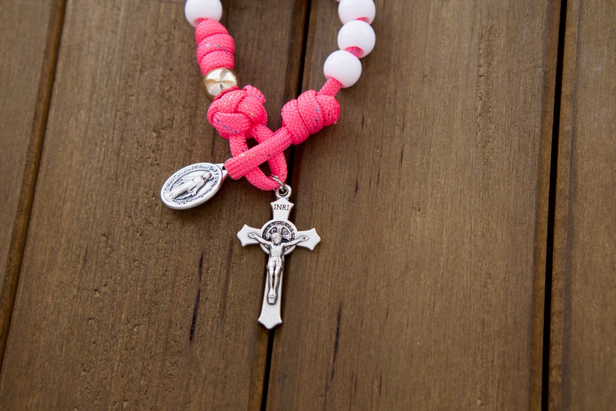 Beautiful kids' pink paracord 1 decade rosary with white Hail Mary beads, rose gold Our Father beads, St. Benedict Crucifix and Miraculous Medal - perfect for First Communion or Easter gifts!