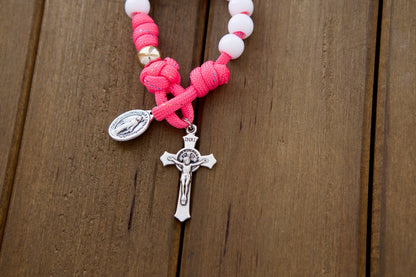 Beautiful kids' pink paracord 1 decade rosary with white Hail Mary beads, rose gold Our Father beads, St. Benedict Crucifix and Miraculous Medal - perfect for First Communion or Easter gifts!