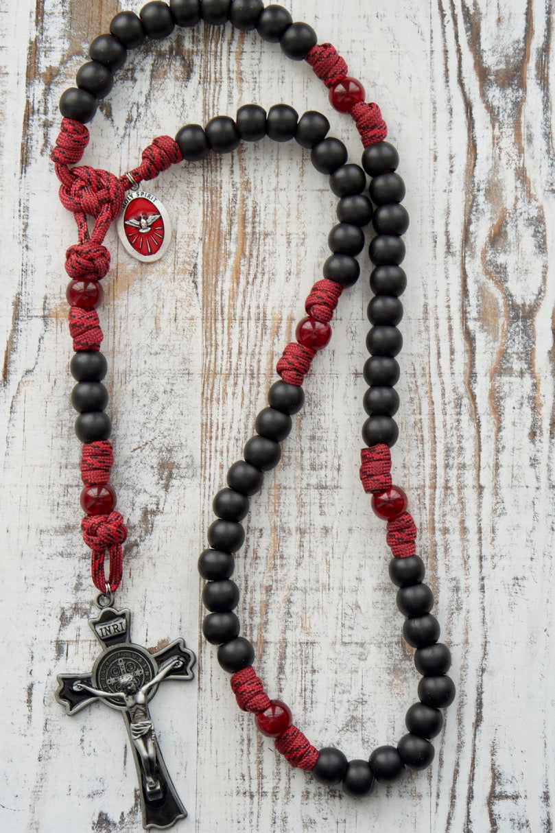 The Crimson Shield - Holy Spirit Confirmation 5 Decade Paracord Rosary, featuring a bold masculine design with sturdy 550 paracord, dark maroon Our Father beads, matte black Hail Mary beads, and a red enamel Holy Spirit devotional medal. Perfect for boys or men preparing to receive the Sacrament of Confirmation.